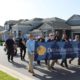 man holding a dream finders homes sign